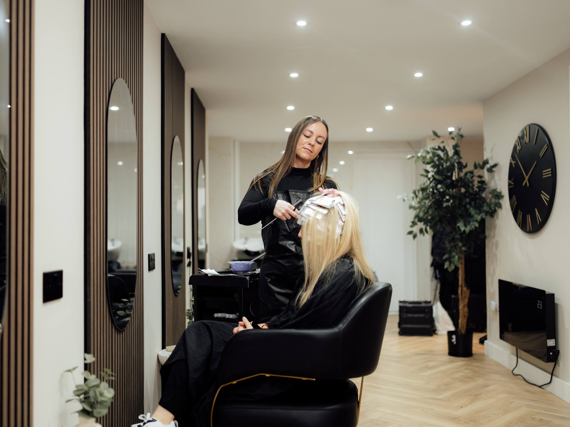 Rebecca applying colour treatment at Amica Lounge salon in Sawtry, Cambridgeshire
